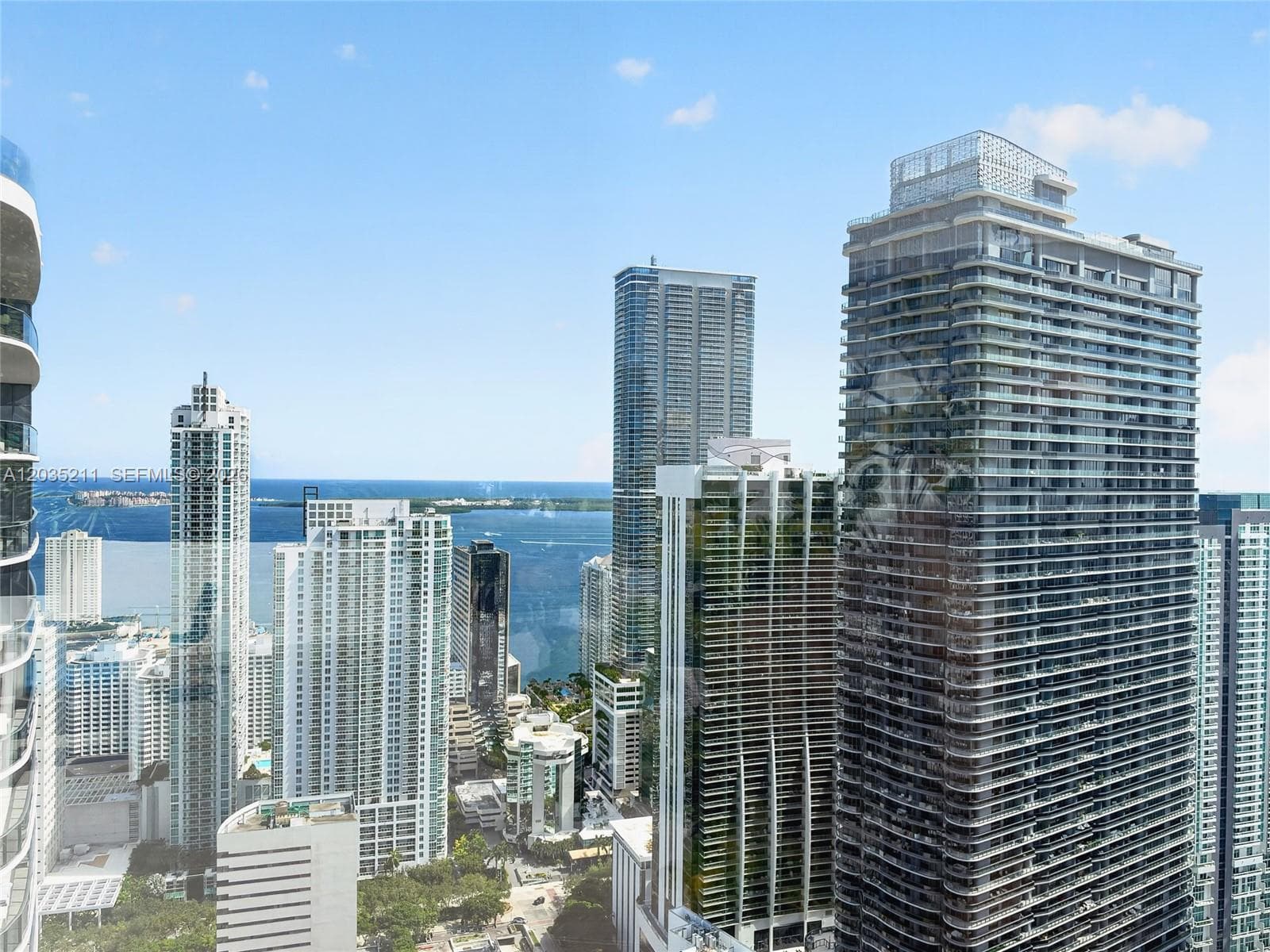 High-rise urban landscape featuring floor-to-ceiling glass and expansive bay scenery
