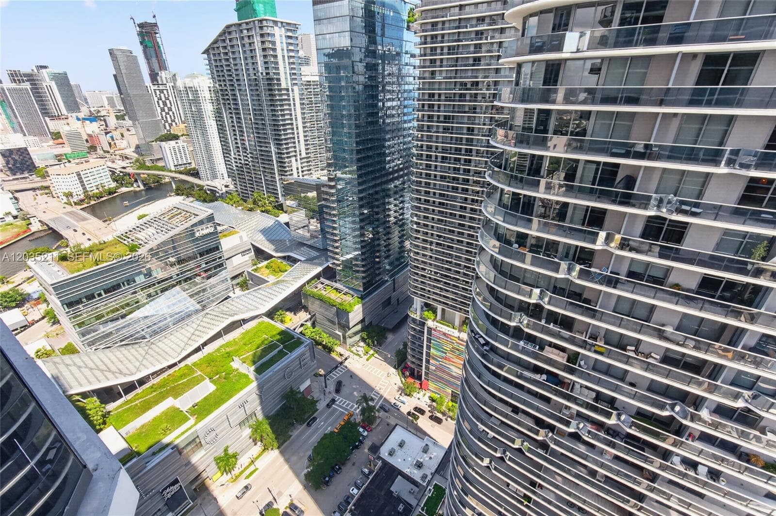 High-rise glass facade featuring wraparound cantilevered balconies, reinforced steel railings, and floor-to-ceiling exterior glazing