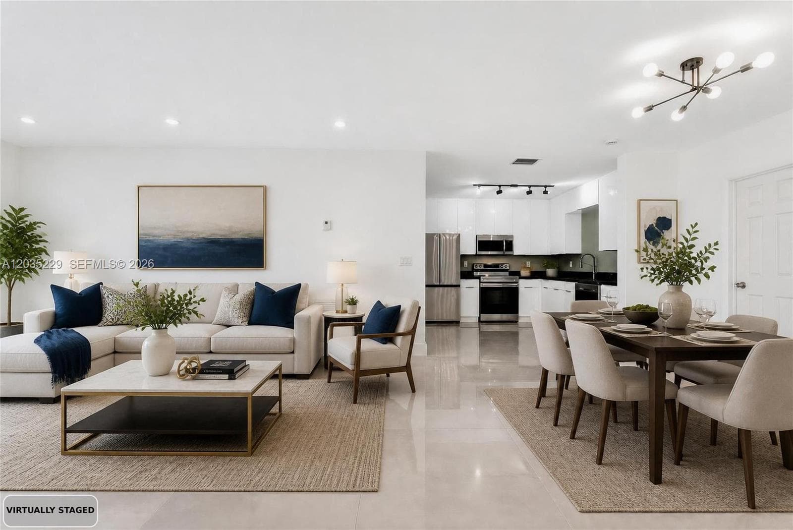 Virtually staged open-concept living, dining, and kitchen area showcasing the home's spacious layout.