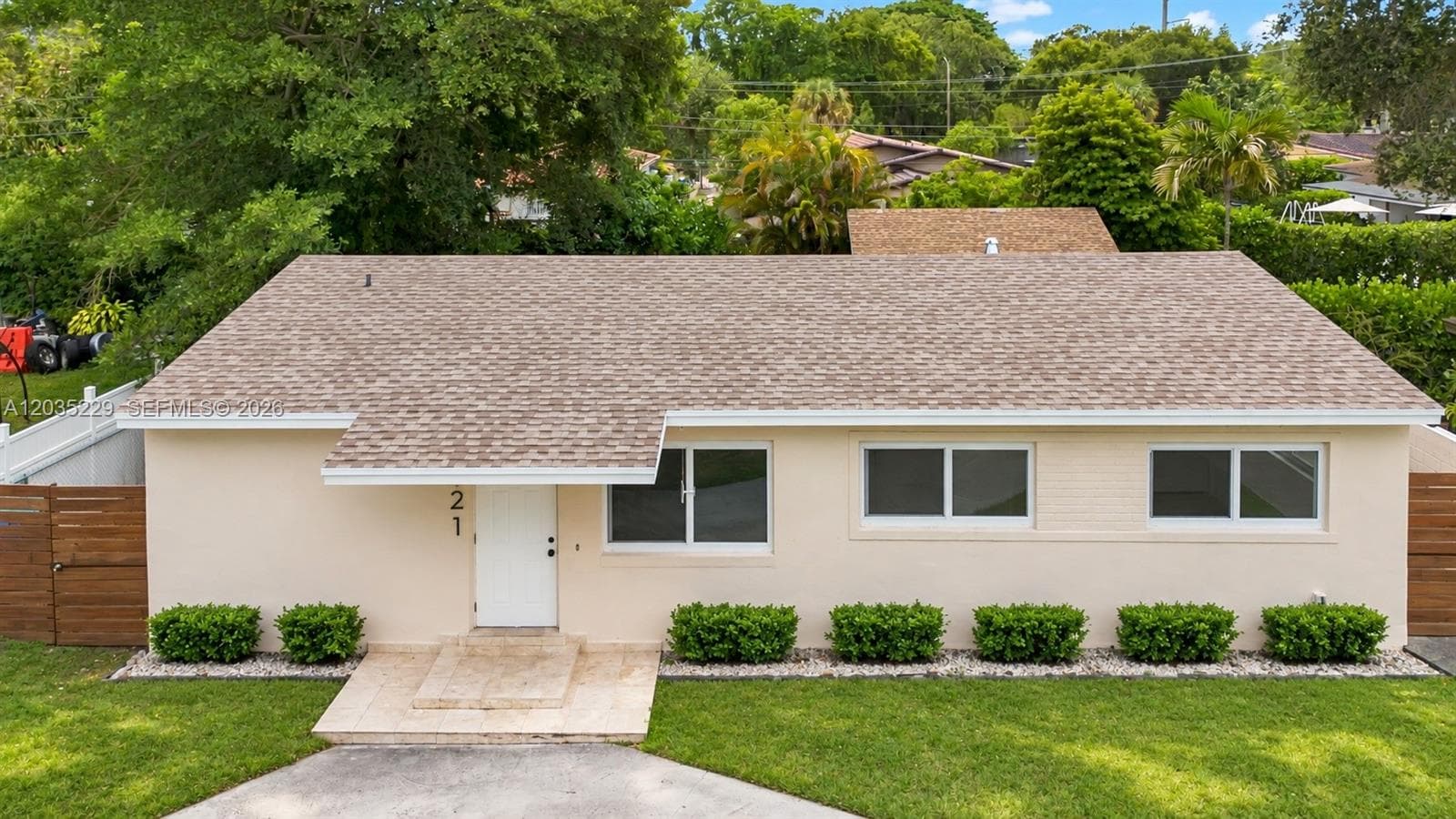 Front aerial view highlighting the home's new roof and updated exterior. AI-edited photograph for marketing purposes.