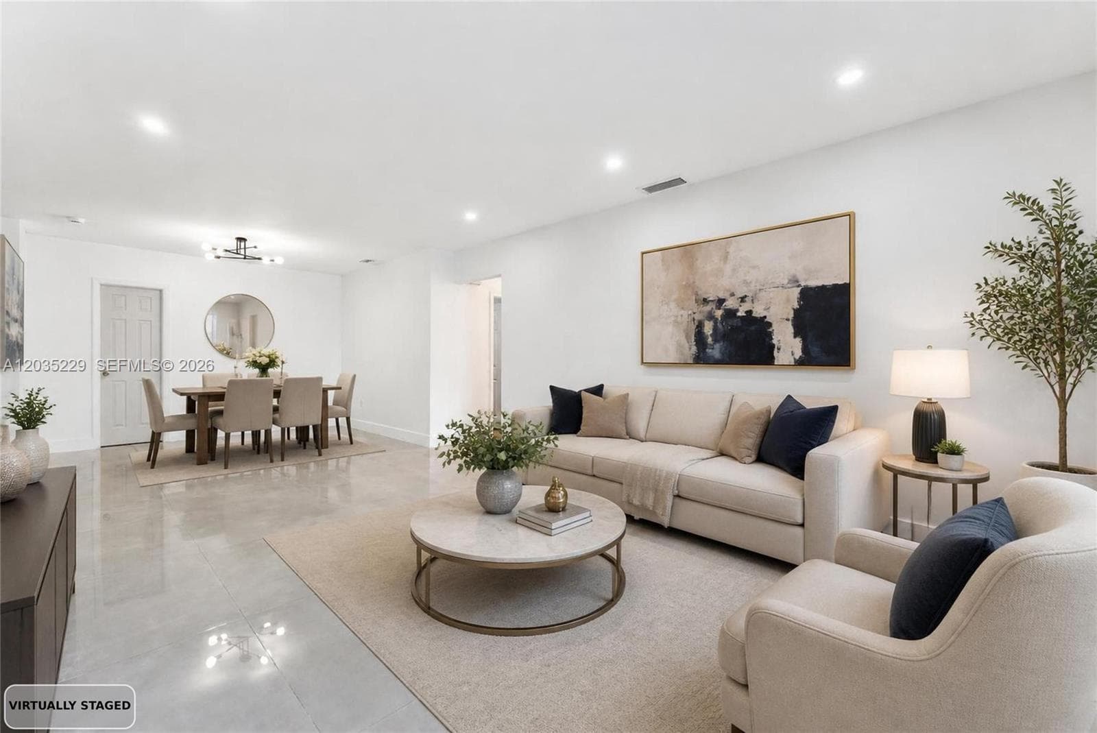 Virtually staged living room and dining area showcasing the open-concept layout.