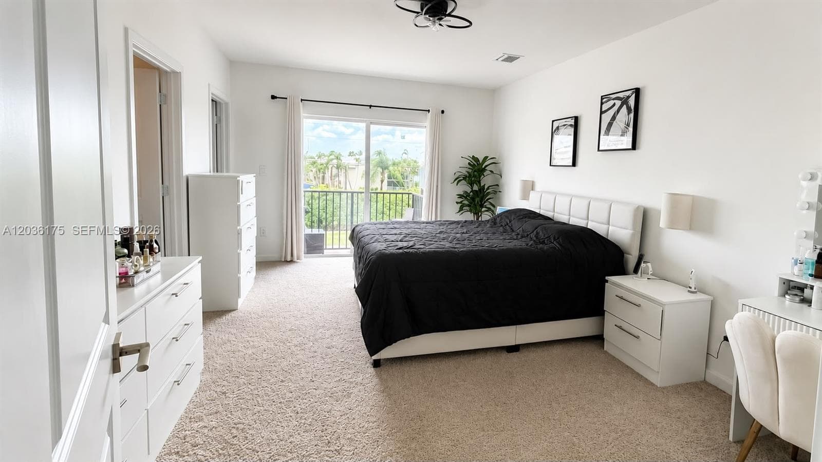 Neutral interior featuring wall-to-wall carpeting, sliding glass doors, and a built-in ceiling light fixture