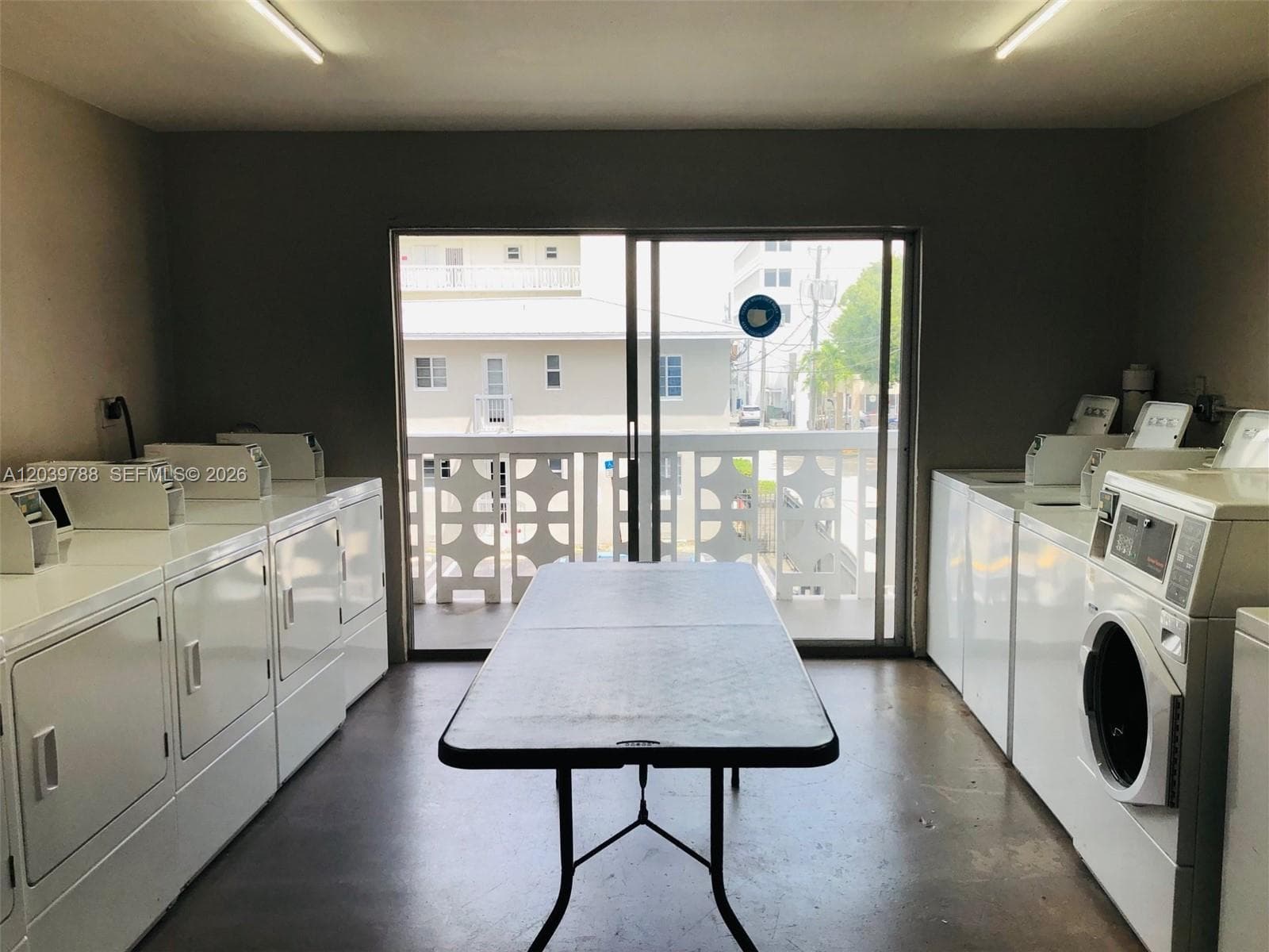 Laundry room with multiple machines