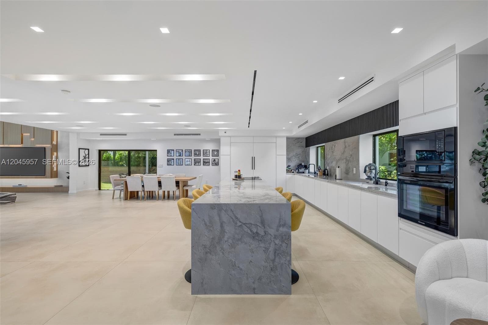 Clean lines, natural stone, and custom cabinetry come together to create a timeless kitchen that serves as the centerpiece of the home.