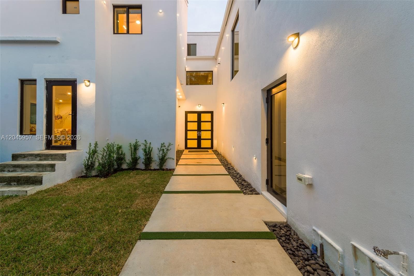 A dramatic architectural entry welcomes you home, setting the tone for the sophisticated design and craftsmanship found throughout the residence.