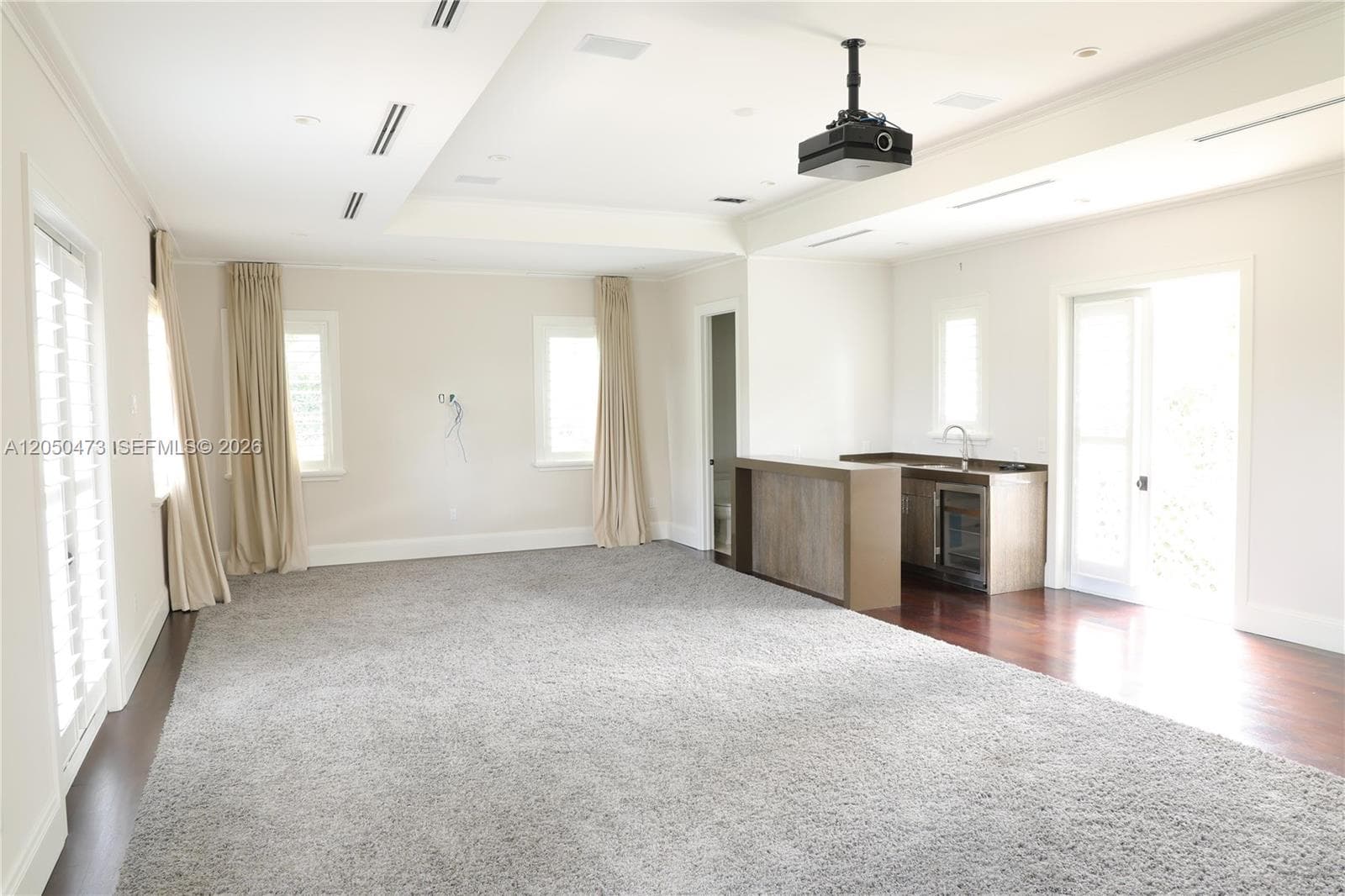 Movie/media/entertainment room with wet Bar, bathroom and 2 balconies facing East and West.