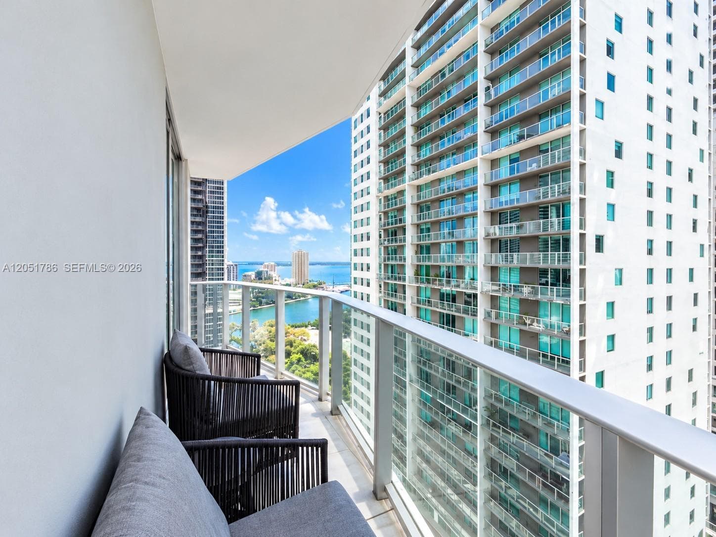 Private balcony featuring a glass-panel railing and concrete flooring