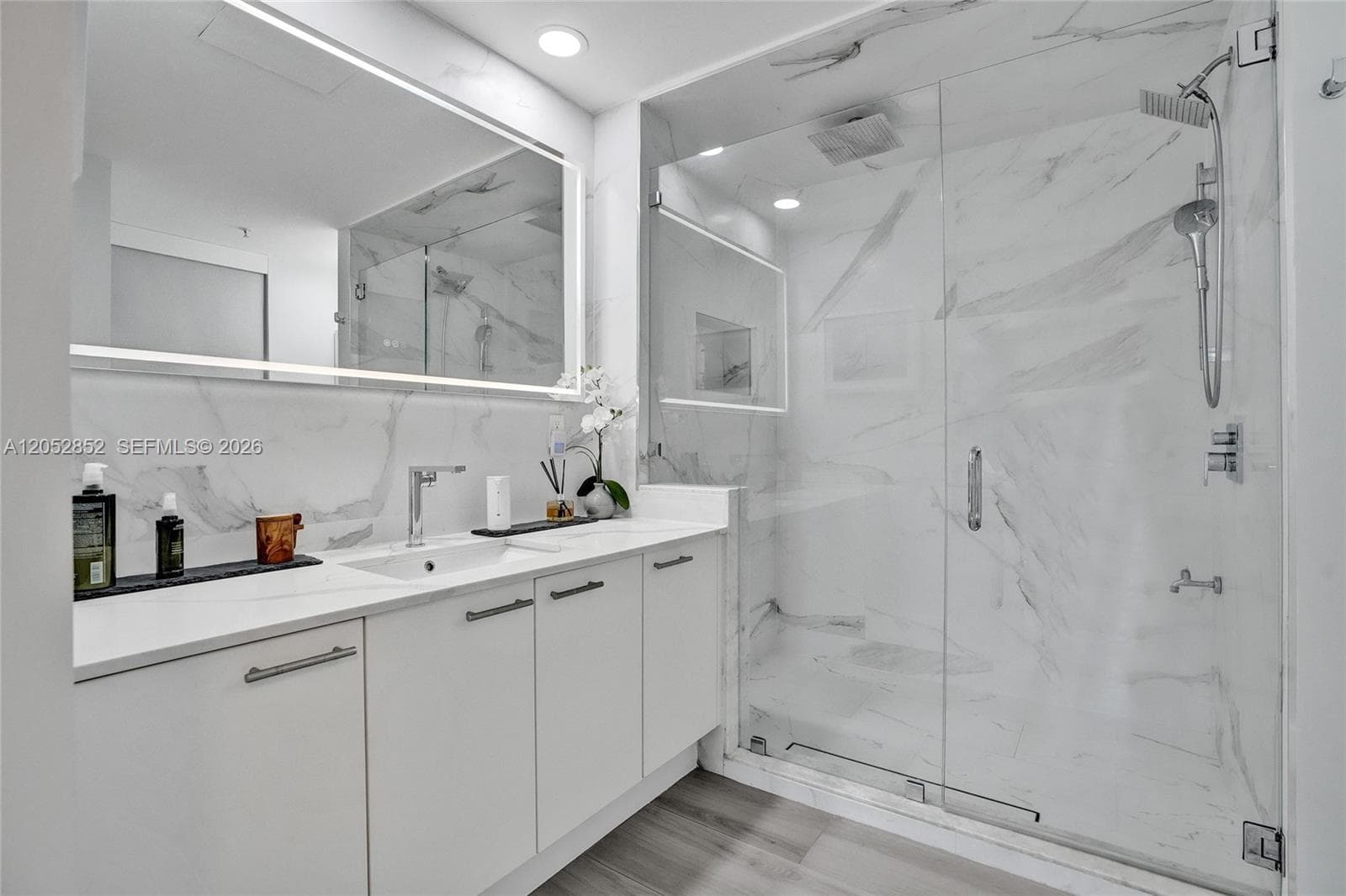 Rainforest showerhead. There are three shower heads in total: one rainforest on the ceiling, one handheld, and one wall-mounted. There is also a hose attachment