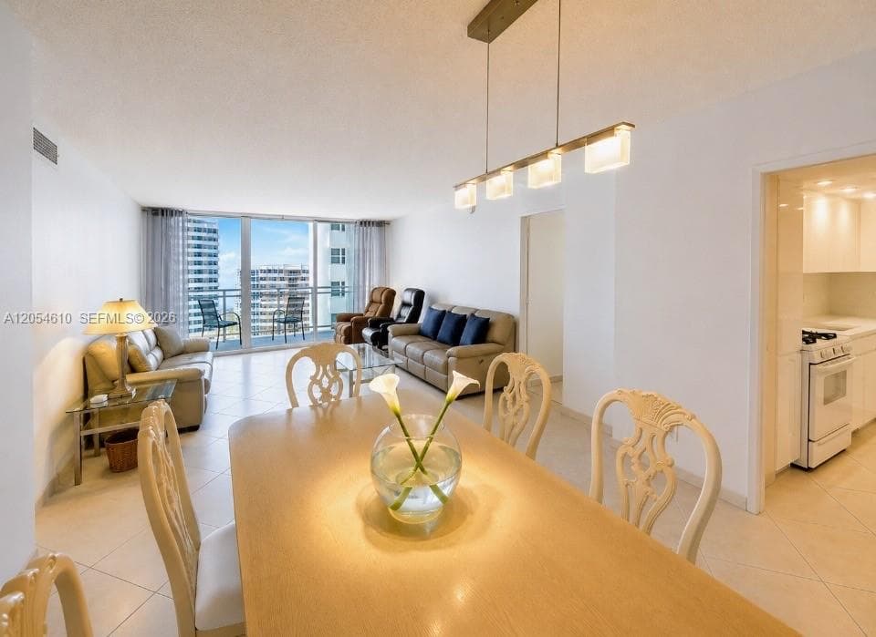 LIVING AND DINING AREAS WITH EASY FLOW TERRACE ACCESS