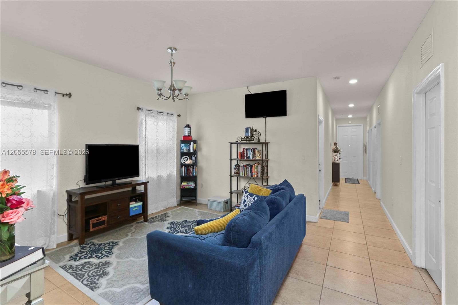 Step into comfort! This inviting living area flows seamlessly from the entryway, creating an open and airy atmosphere that’s perfect for relaxation and welcoming guests.