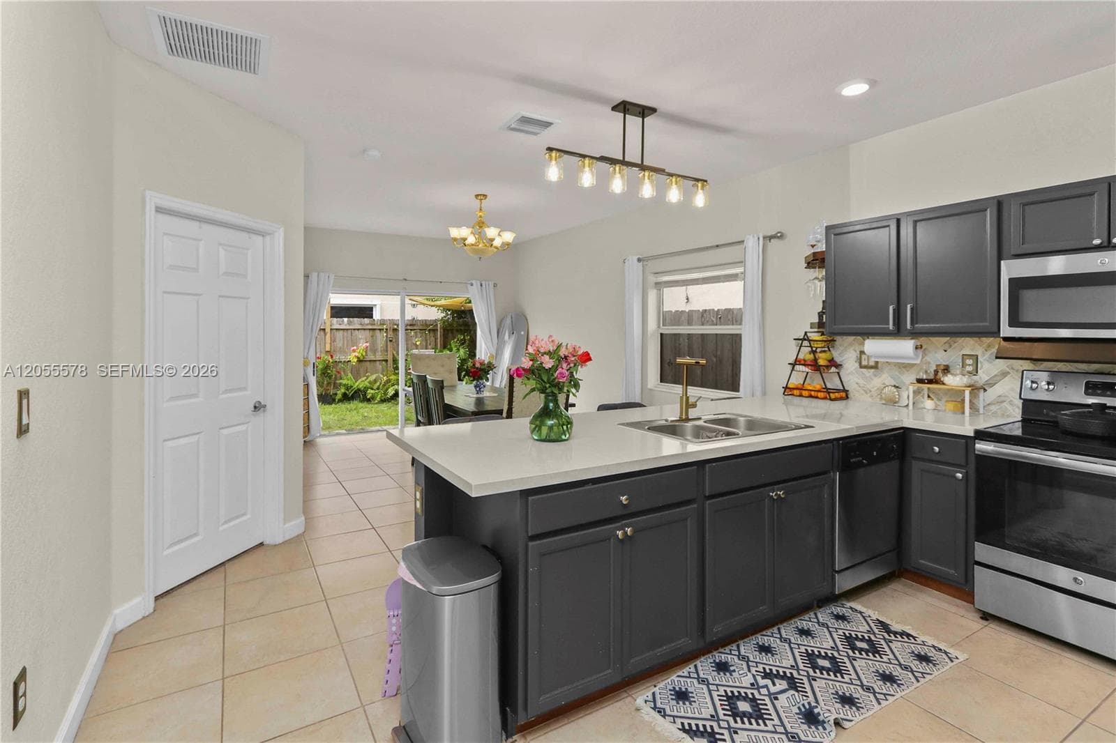 Seamless indoor-outdoor living! This kitchen view highlights the direct access to the backyard, perfectly blending culinary convenience with a bright, airy connection to your private outdoor space