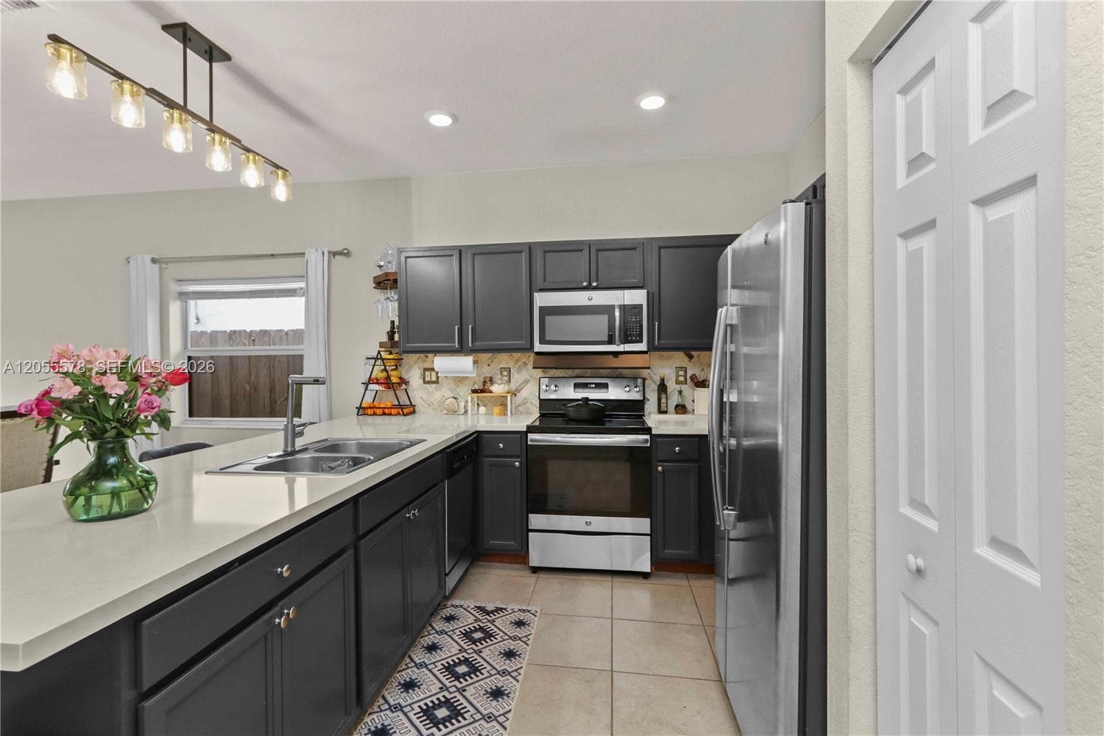 A chef’s delight! This modern kitchen features sleek dark cabinetry, elegant countertops, and stainless steel appliances, offering a sophisticated space that is as functional as it is beautiful.