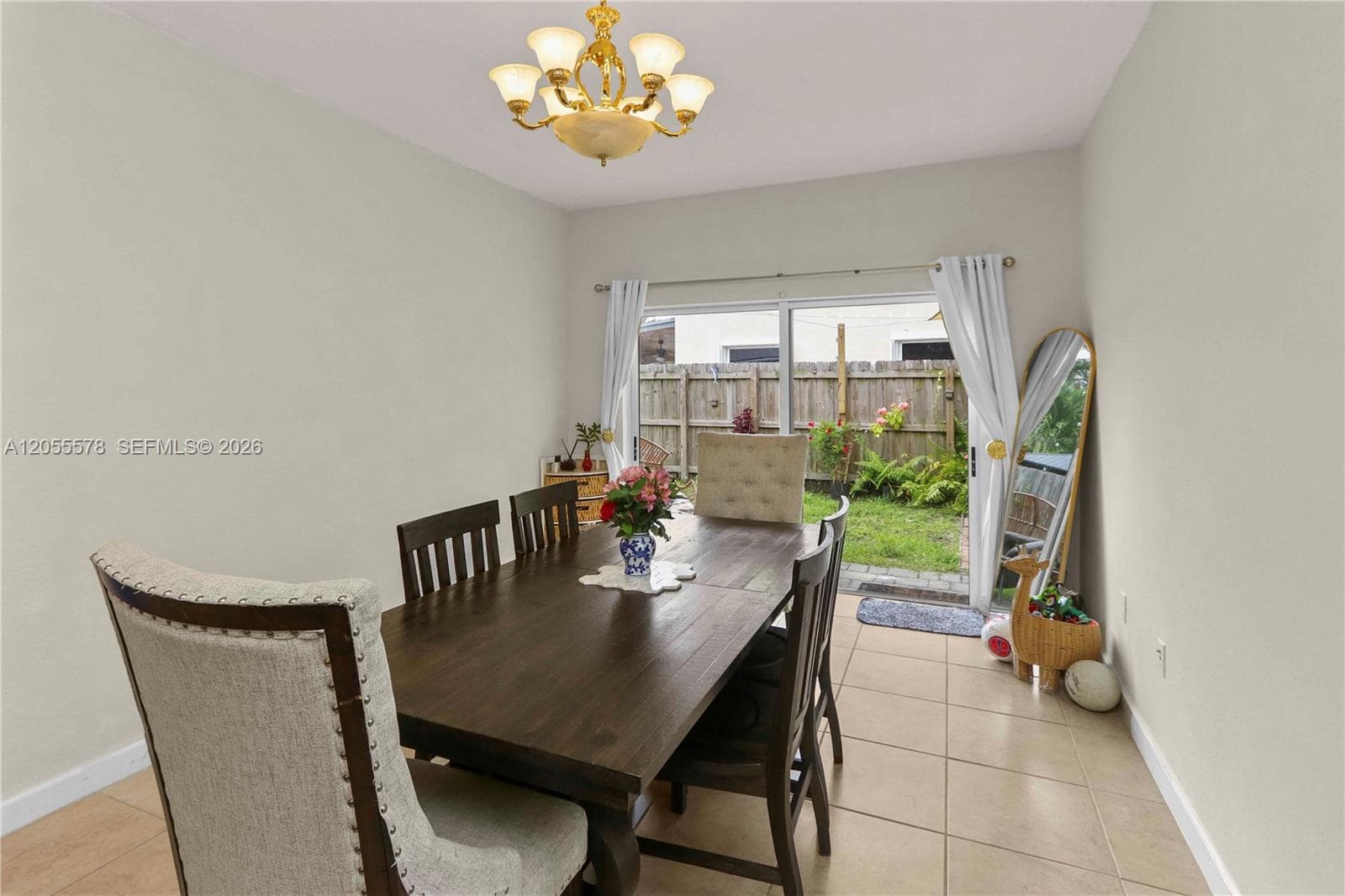 Dine with a view! This elegant dining area features a warm, welcoming ambiance with a seamless transition to the backyard, making it the perfect setting for memorable family meals and gatherings.