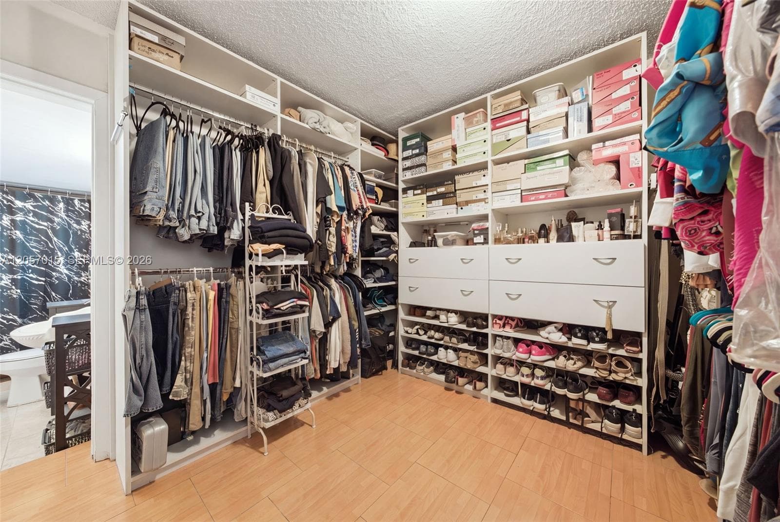 Bedroom made in to a closet. This bedroom has its own bathroom with walk in shower.