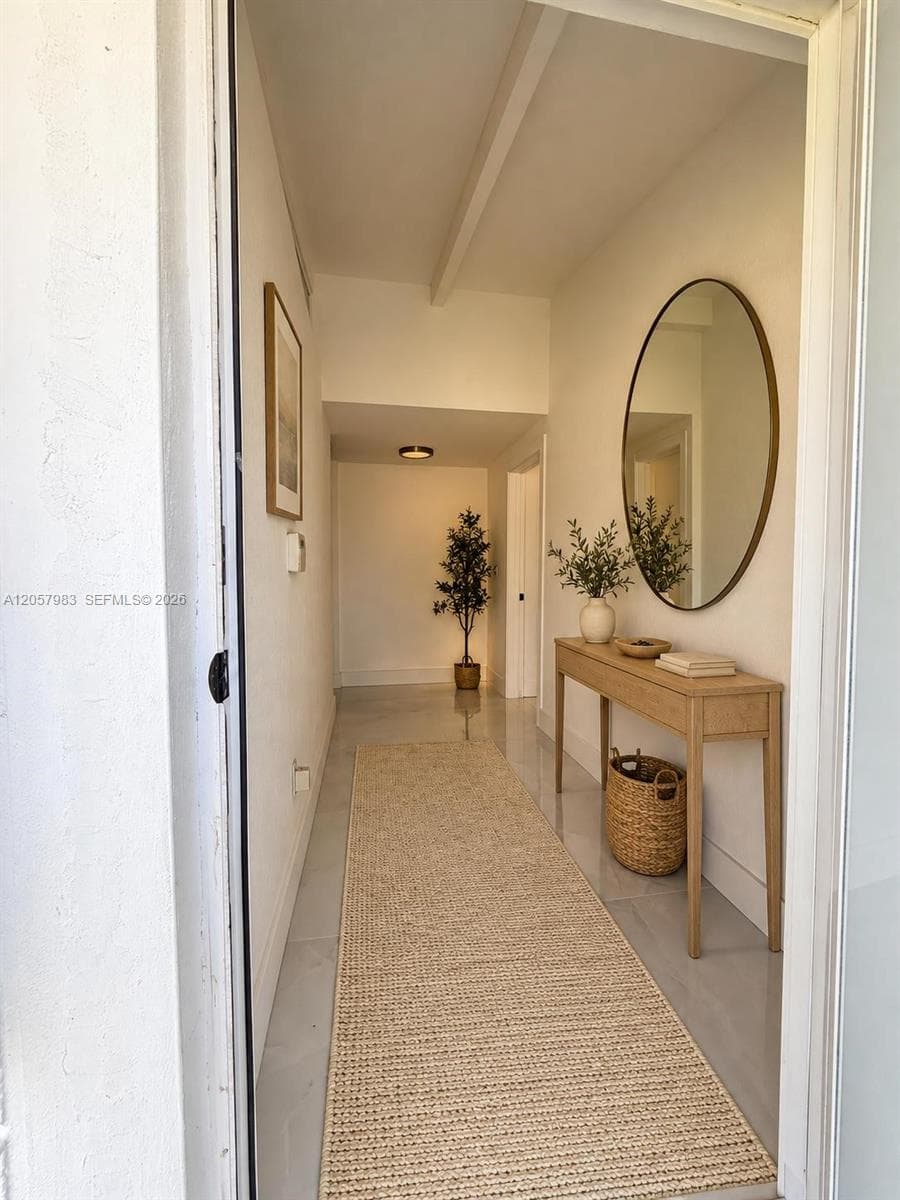 Recessed lighting throughout, exposed ceiling beam, and light-toned flooring