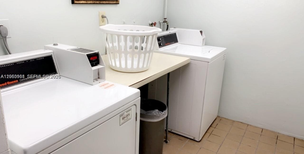 Laundry area featuring a built-in folding counter and tile flooring