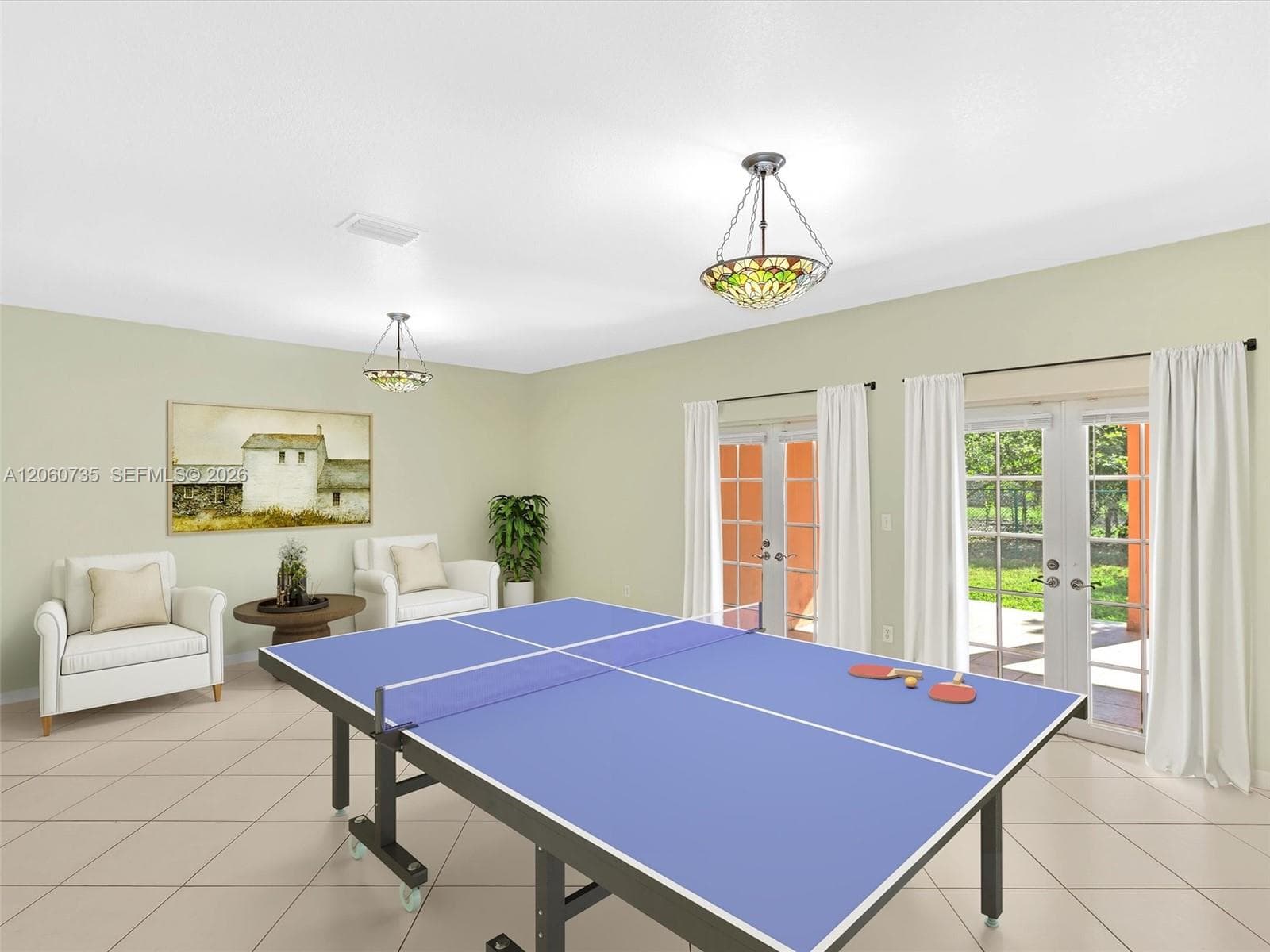 This family room is perfect for entertaining, it opens to an expansive covered terrace and backyard. Virtually Staged photo.