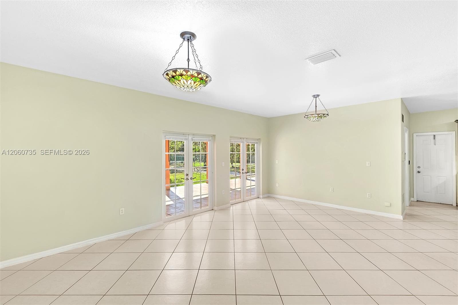 This family room is perfect for entertaining, it opens to an expansive covered terrace and backyard.