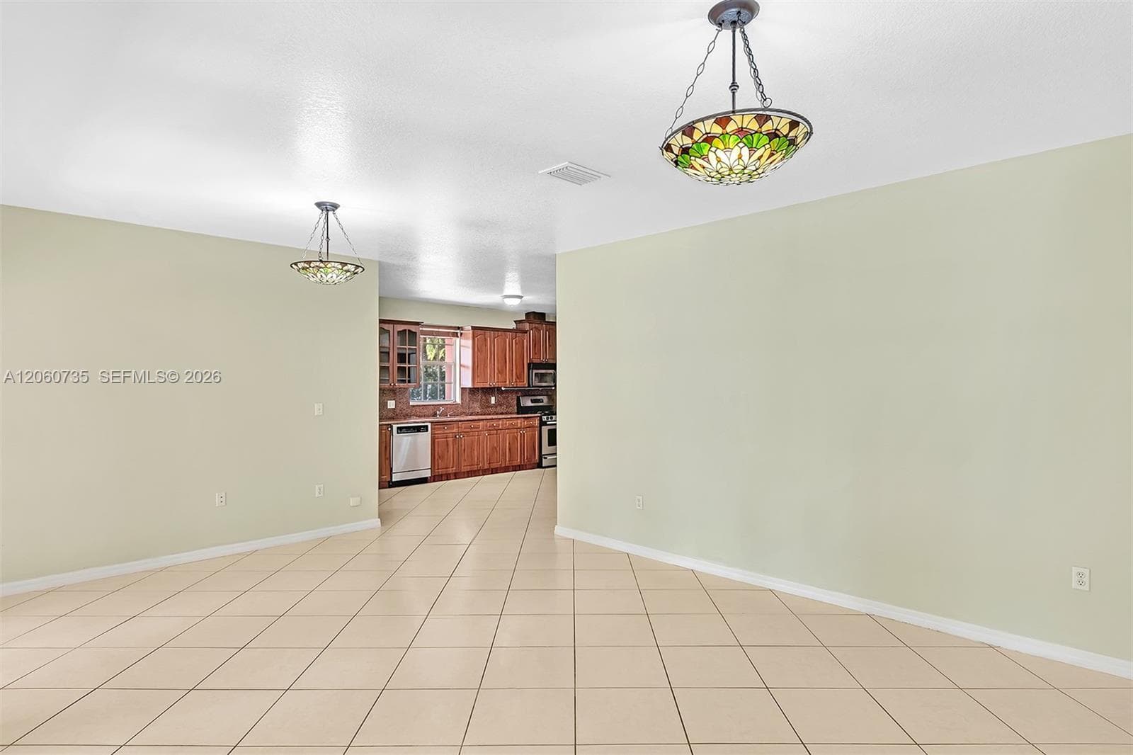 This family room is perfect for entertaining, it opens to an expansive covered terrace and backyard.