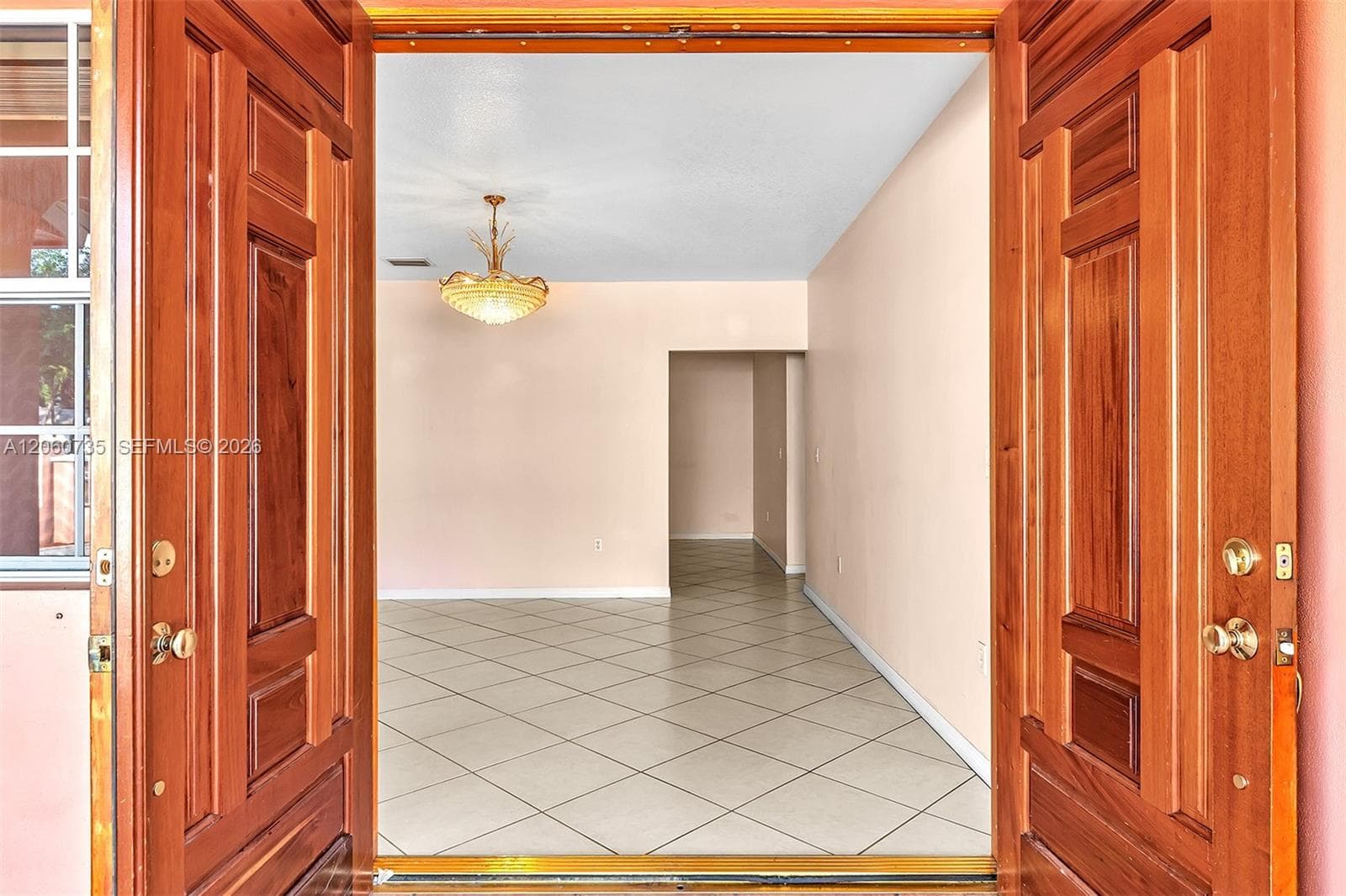 Wide Doble Doors open to the Formal Living room.