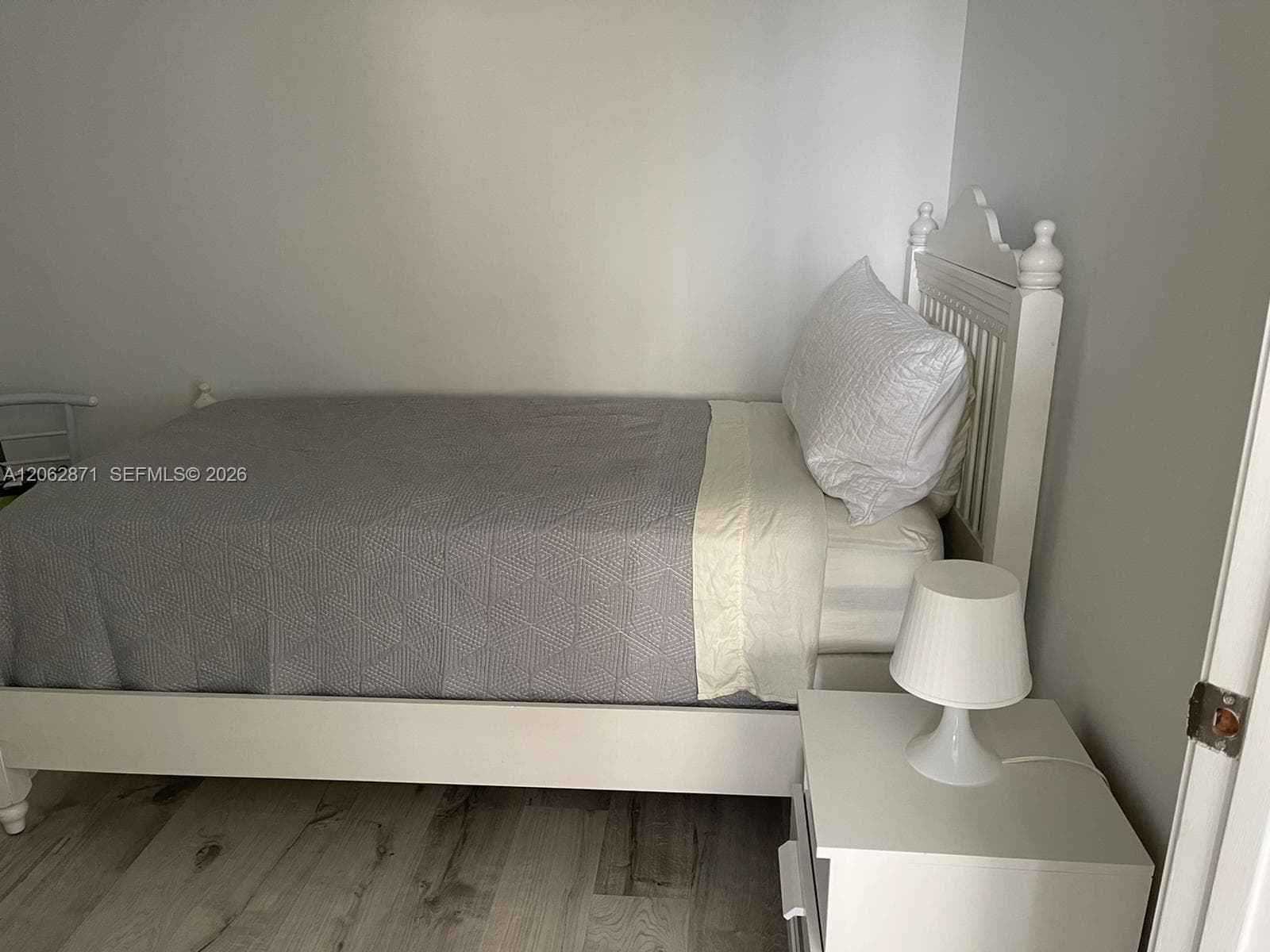 Den with twin bed and dresser and night table