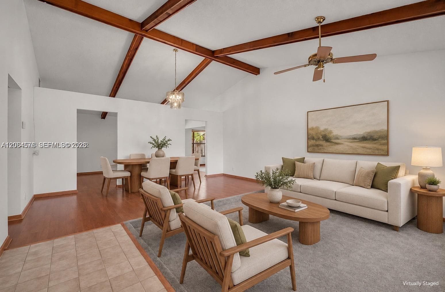 Vaulted ceilings featuring exposed wood beams, wood-finish flooring, and a ceiling fan with integrated lighting
