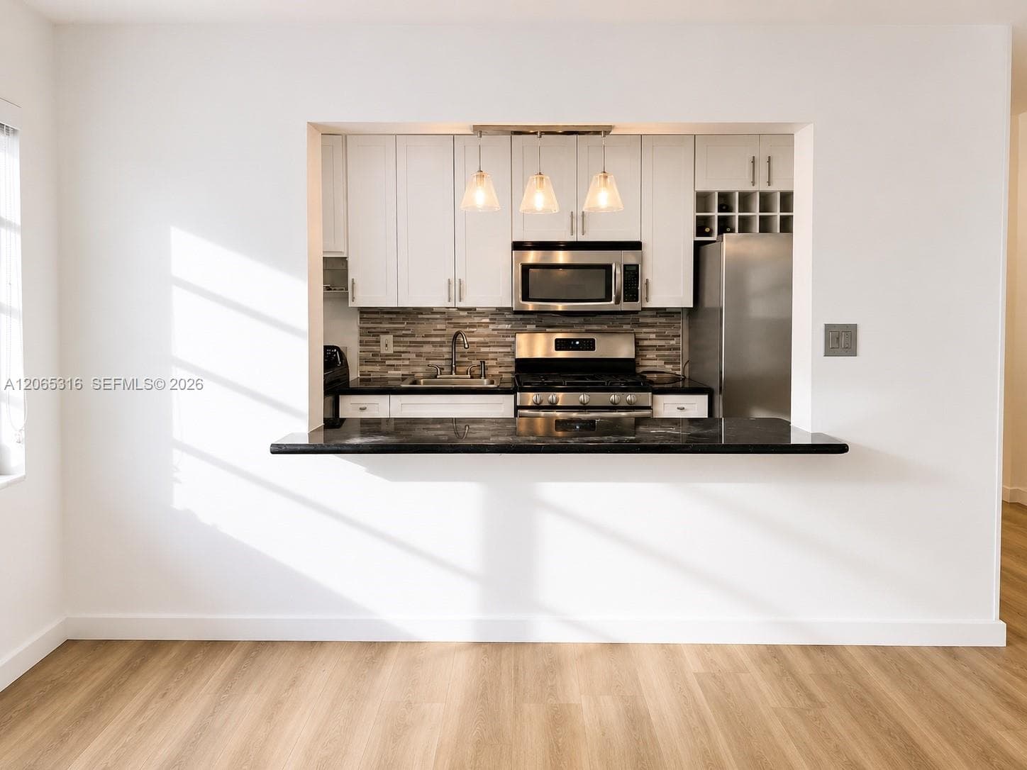Open dining area seamlessly connected to the living room and renovated kitchen.
