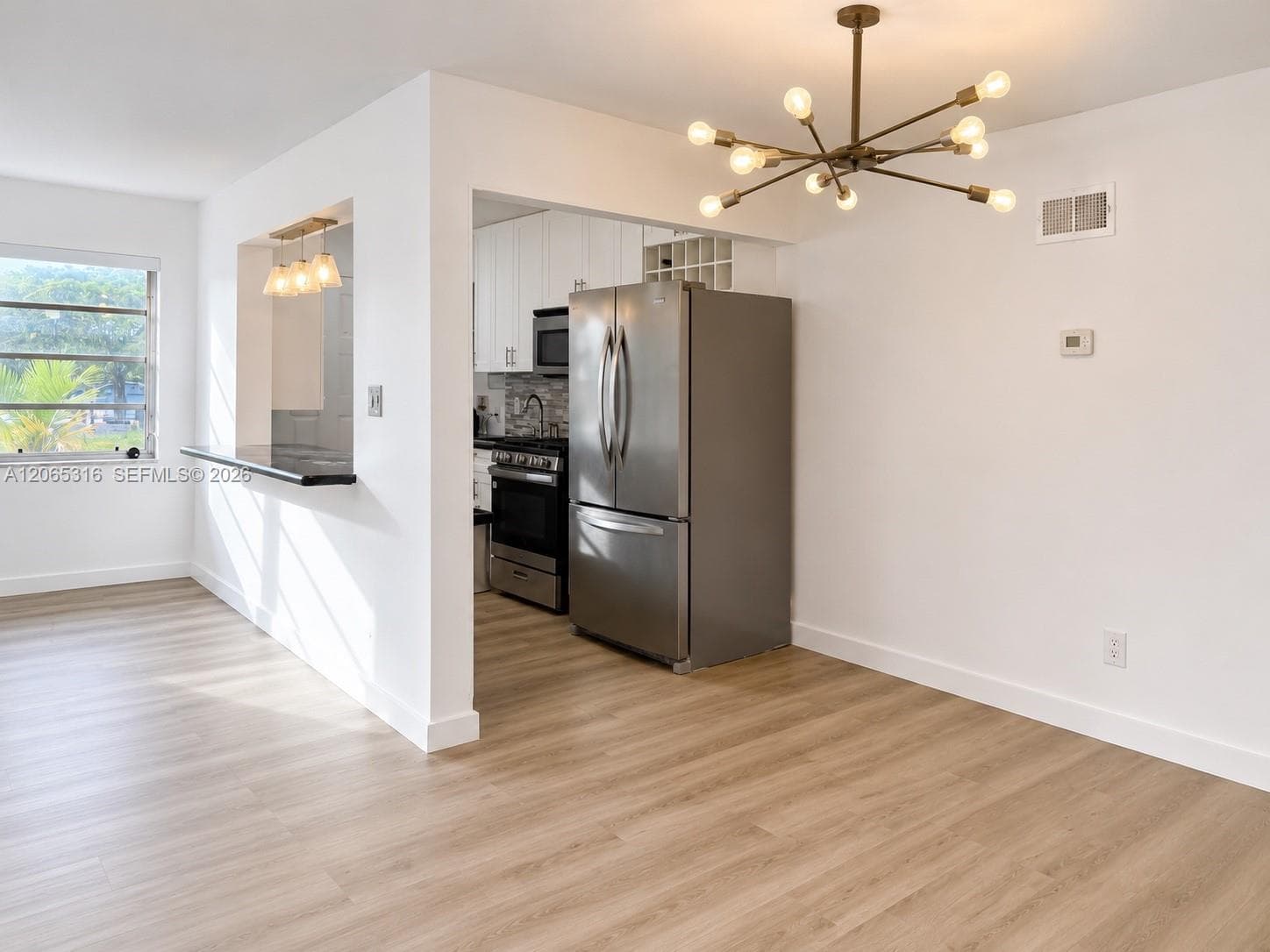Open-concept kitchen overlooking the bright main living area.