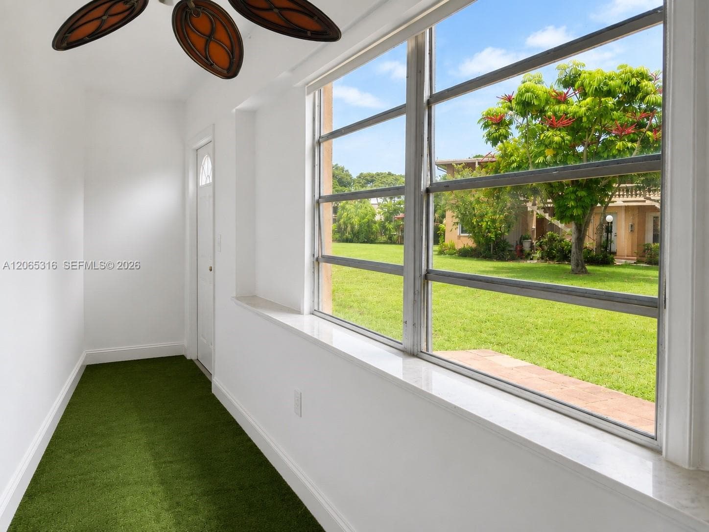 Enclosed bonus room ideal for a home office, reading area, hobby room, or additional sitting space.