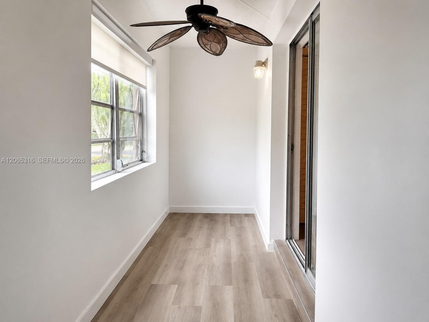 Additional bonus-room view featuring abundant natural light and peaceful community views.