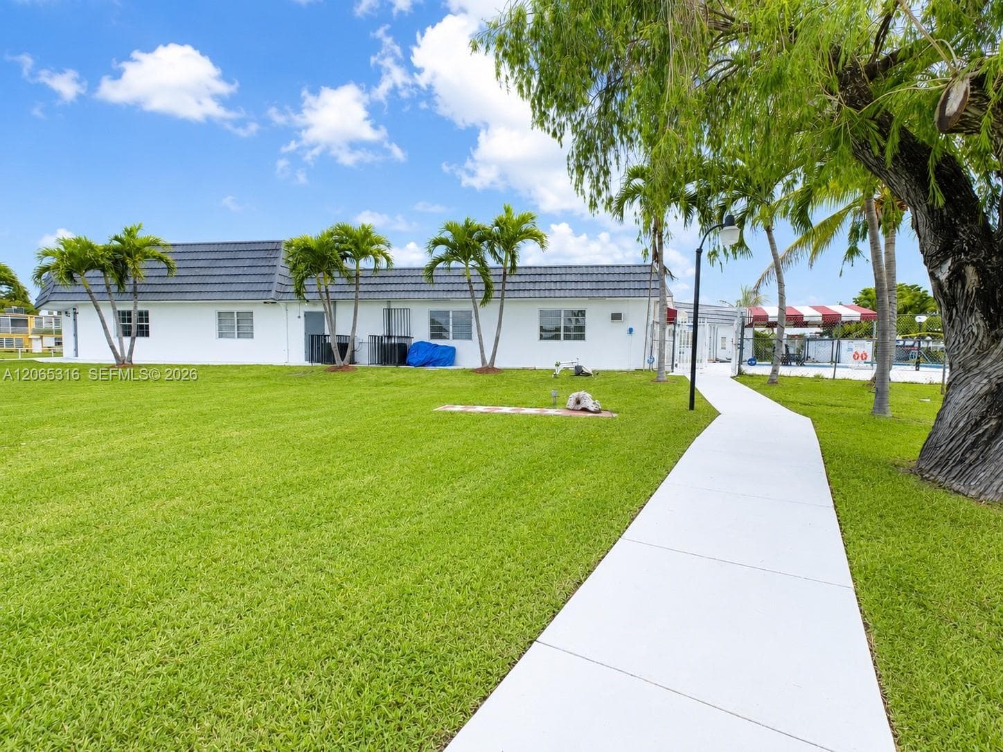 Beautifully landscaped community grounds with mature trees and green spaces.
