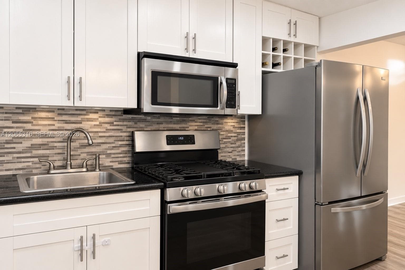 Updated kitchen featuring quartz countertops, modern cabinetry, and stainless-steel appliances.