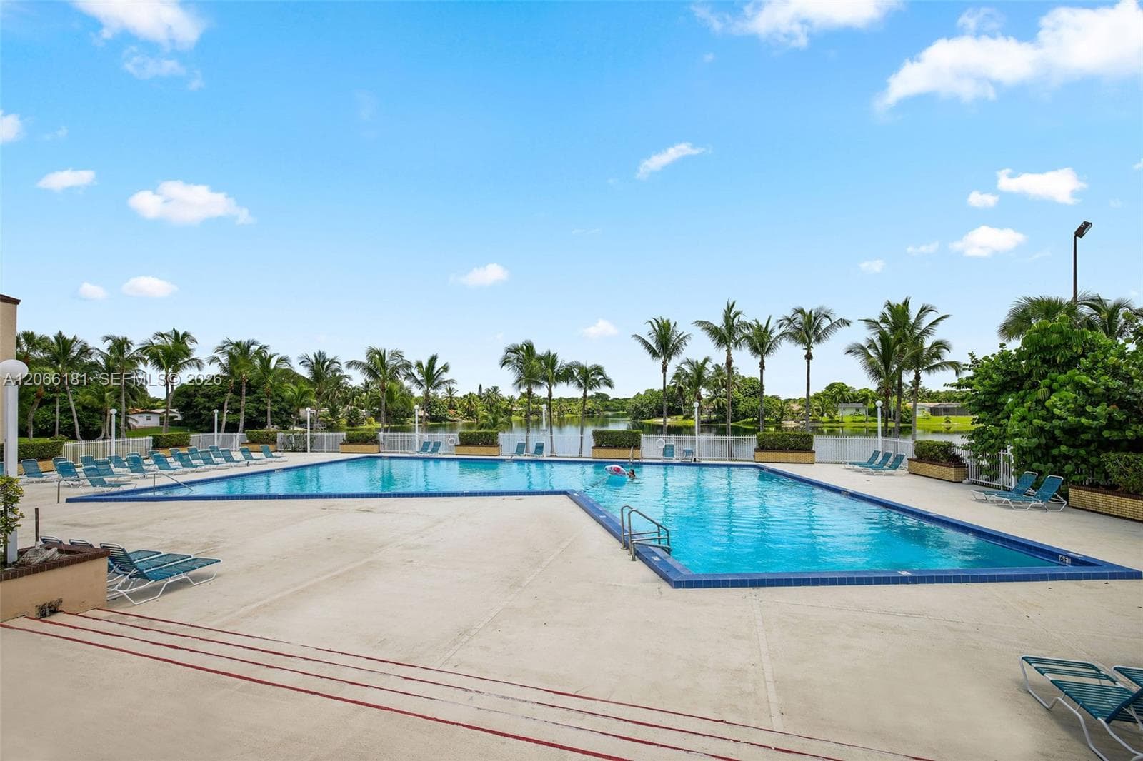 Resort style main swimming pool parallels the lake