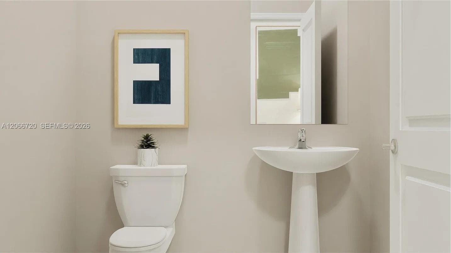 A powder room tucked off the foyer meets the needs of the whole household and visiting guests.