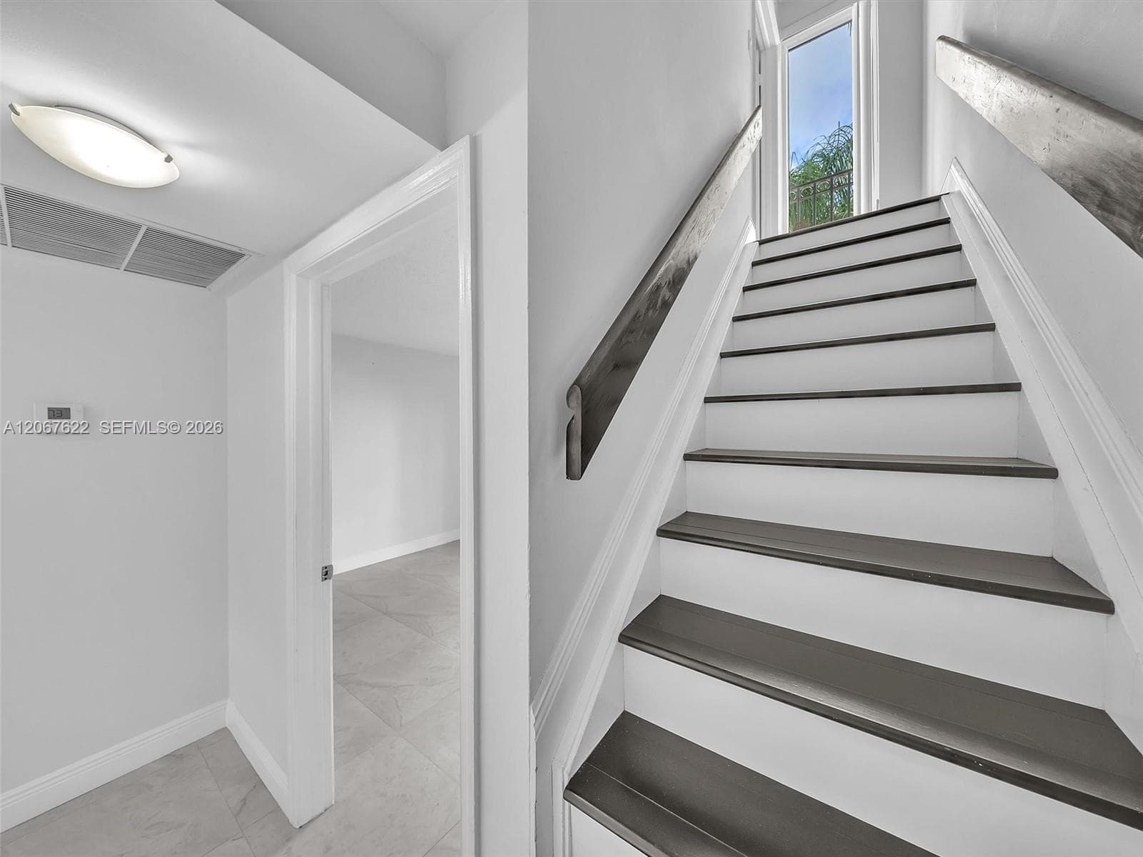 Nicely remodeled stairs and railings with ample light.