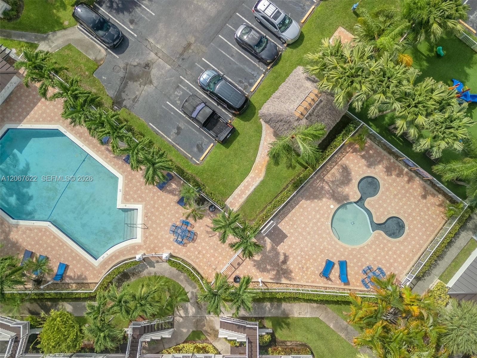 Separate adult and children's pools with lush landscape and very well maintained community