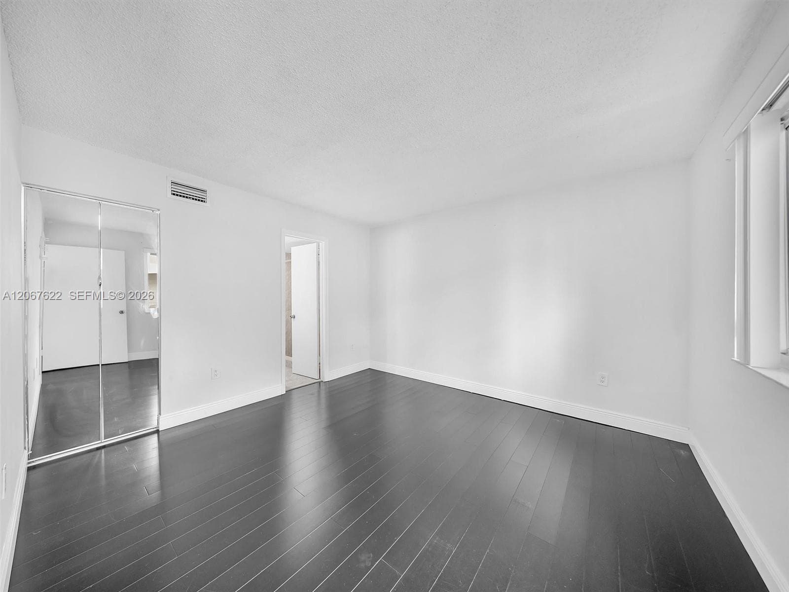Primary suite upstairs with great walk-in closet and great natural light. Floors are a beautiful and modern dark brown.