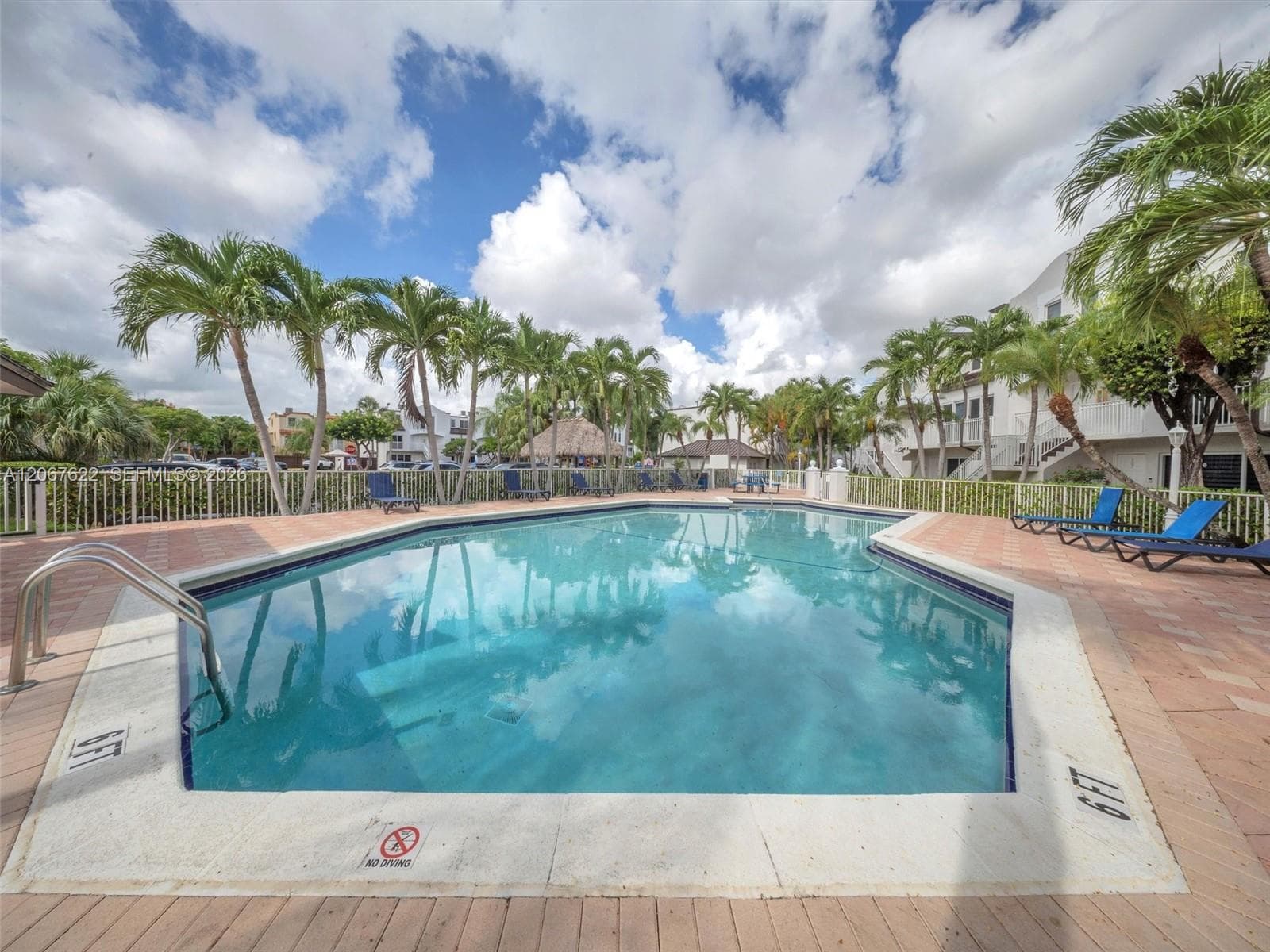 Community pool features lounge chairs and also restrooms
