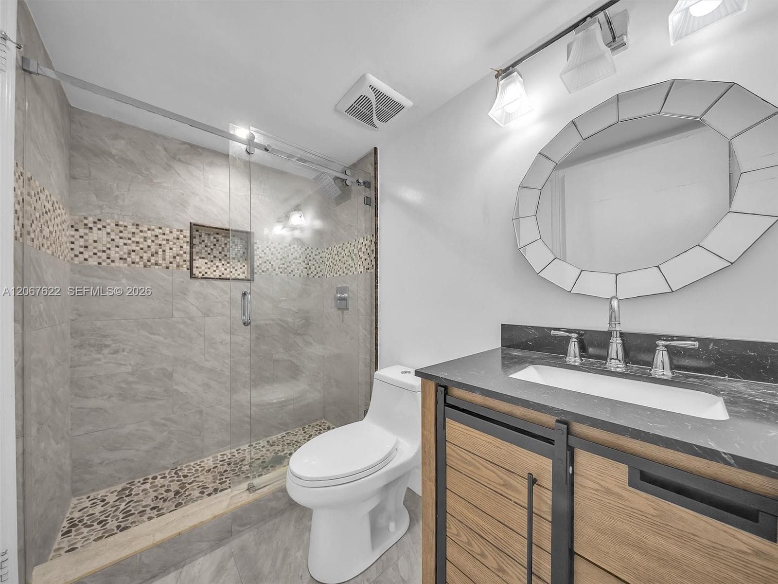 En suite bathroom with separate access for guests through the hallway (no need to enter the bedroom for guest access).Glass shower enclosure.
