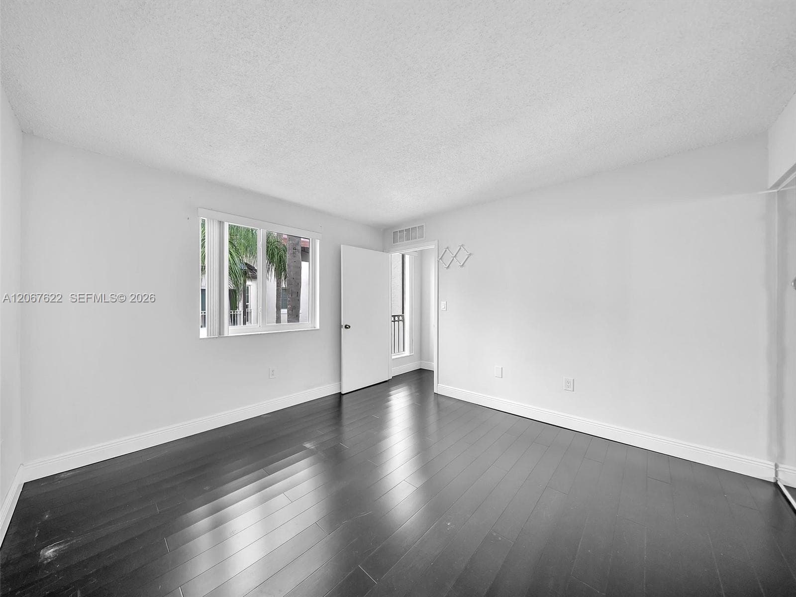 Primary suite upstairs with great natural light (new impact windows).