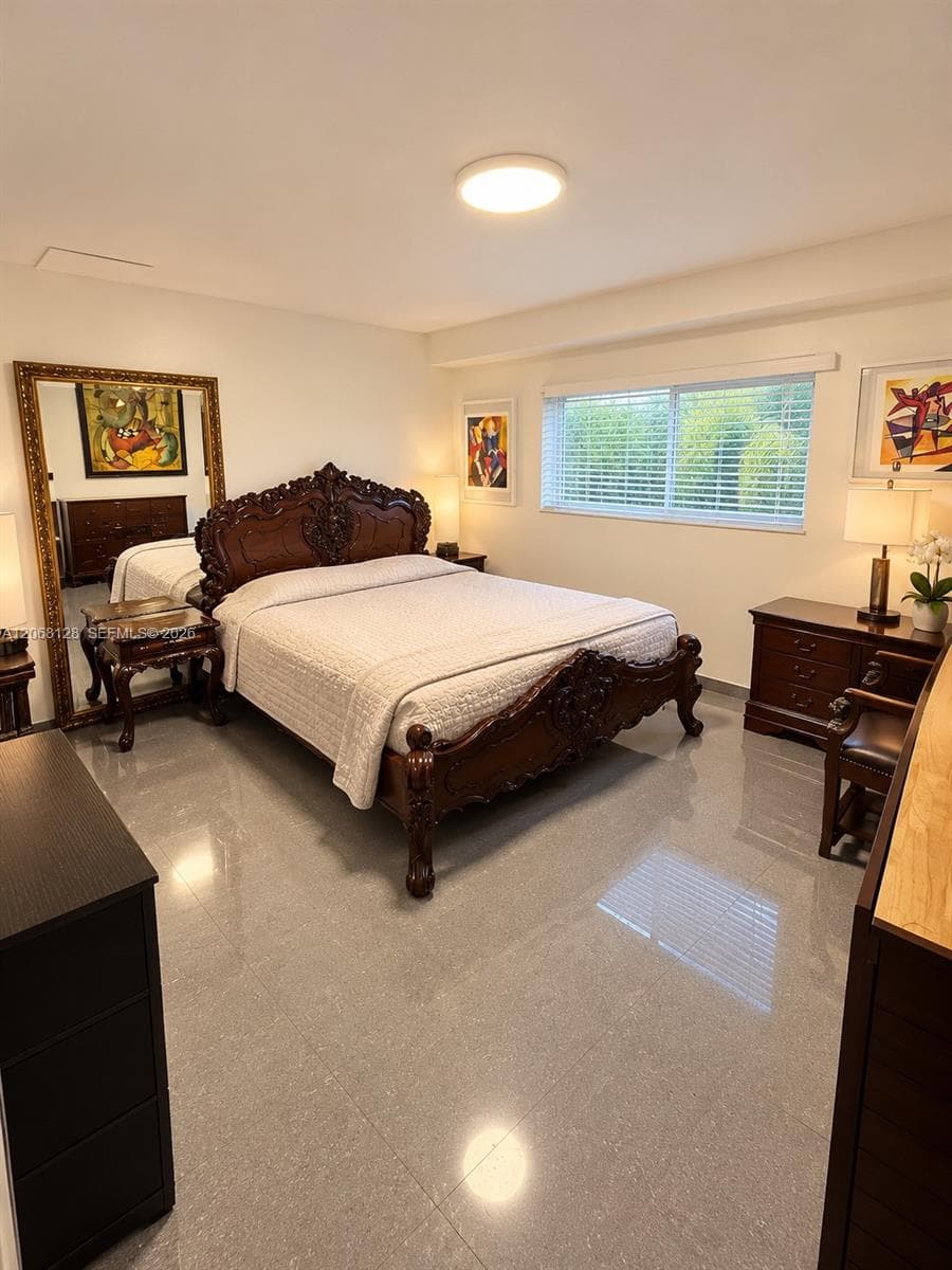 Polished stone flooring, flush-mount ceiling lighting, and a window with horizontal blinds