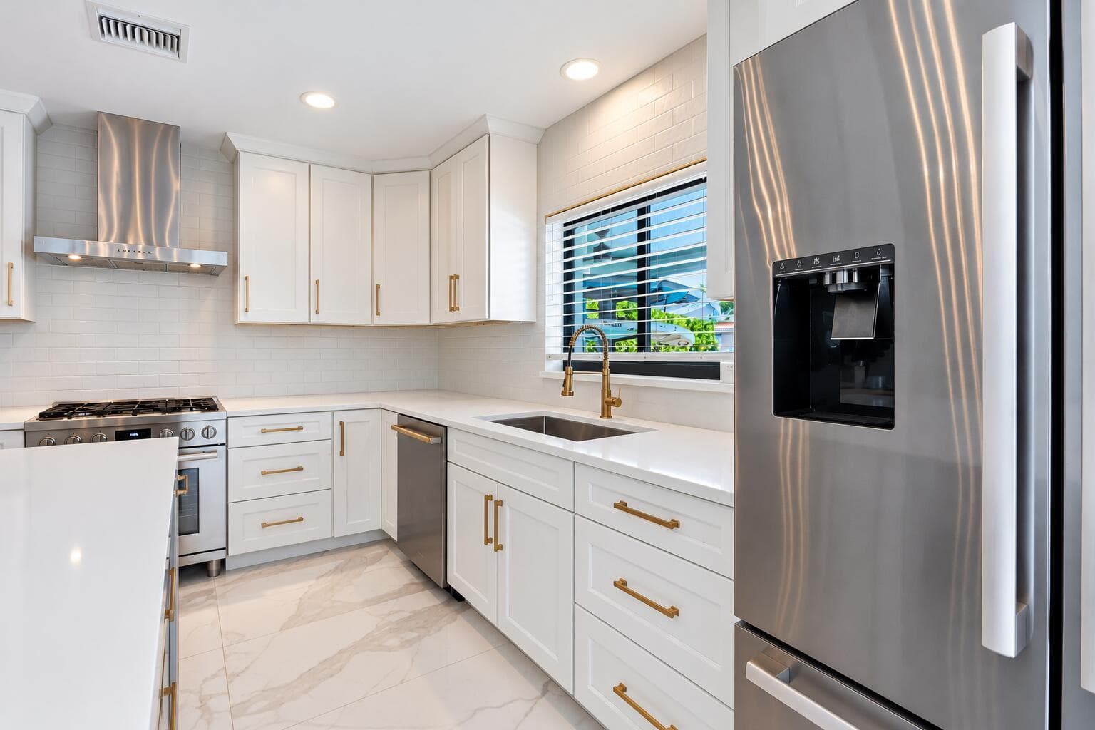 Minimalist White Kitchen with Brass Acce