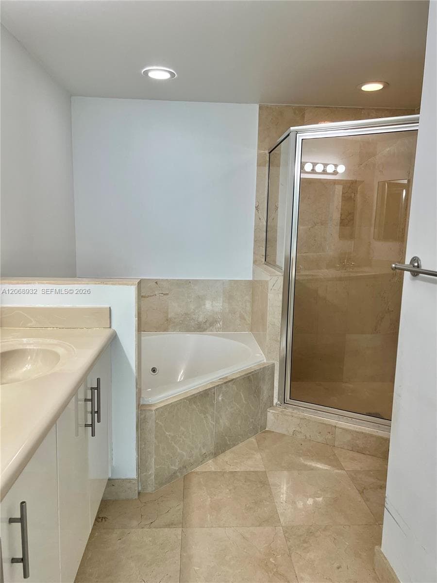 Master bathroom with bathtub and shower