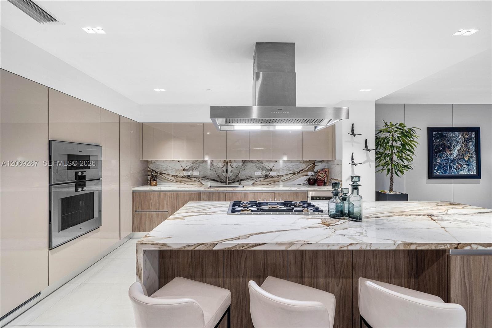 A sophisticated Italian-designed kitchen featuring custom cabinetry, premium Gaggenau appliances, gas cooking and an elegant island ideal for entertaining.