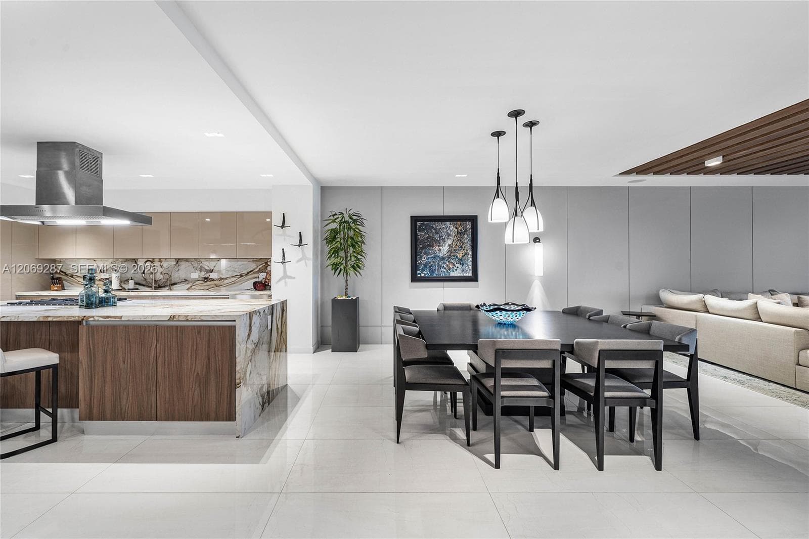 An elegant dining area  offering beautiful waterfront views and a seamless setting for entertaining.