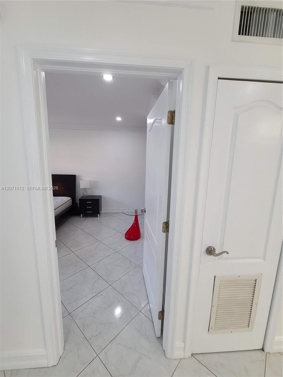 Entry to Living room. Right door is the A/C closet, followed by another closet