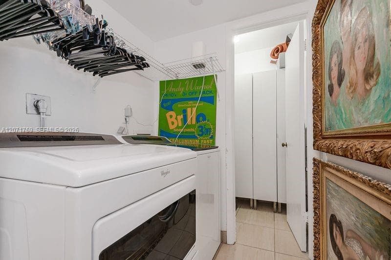 laundry room with additional storage closet
