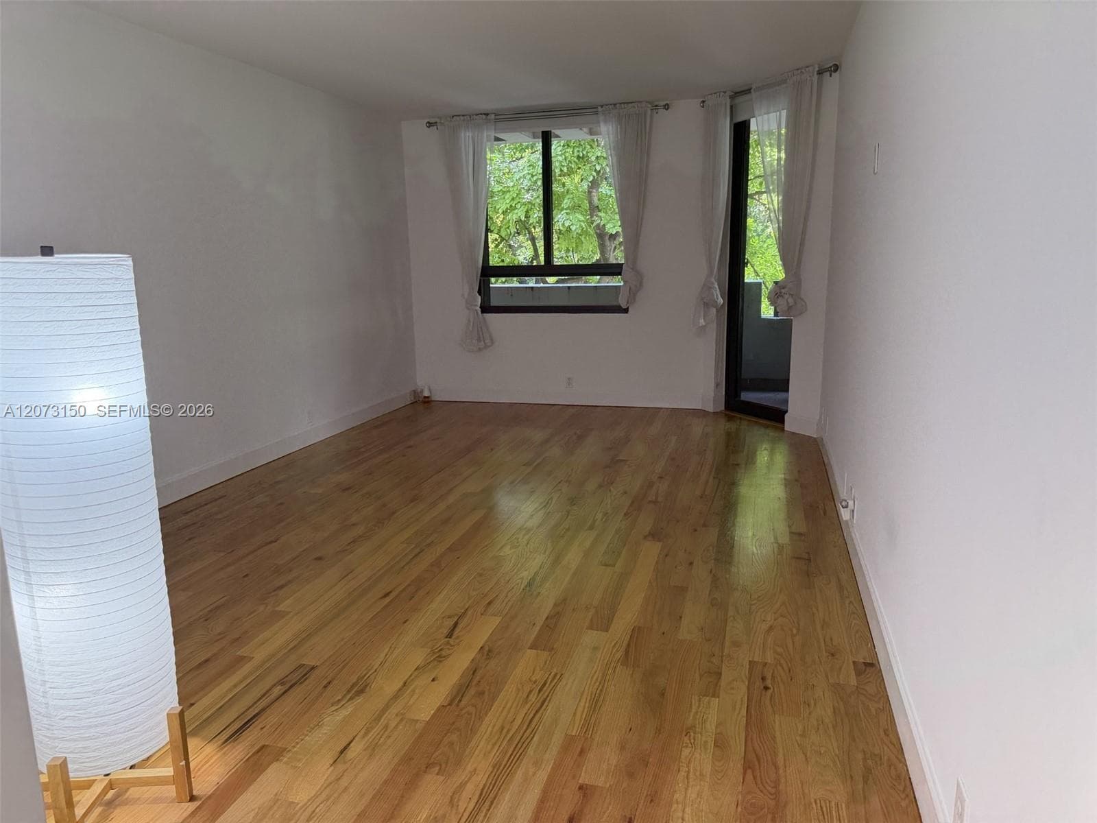 Wood-finish flooring and floor-to-ceiling glass sliding doors