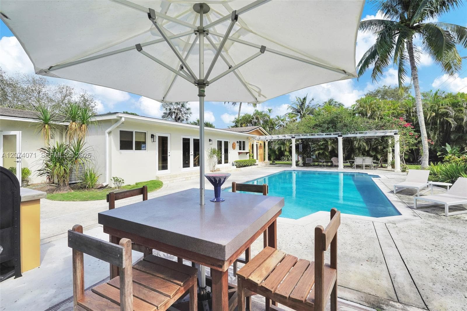 Outdoor firepit and seating area for cozy evenings under the Palmetto Bay sky.