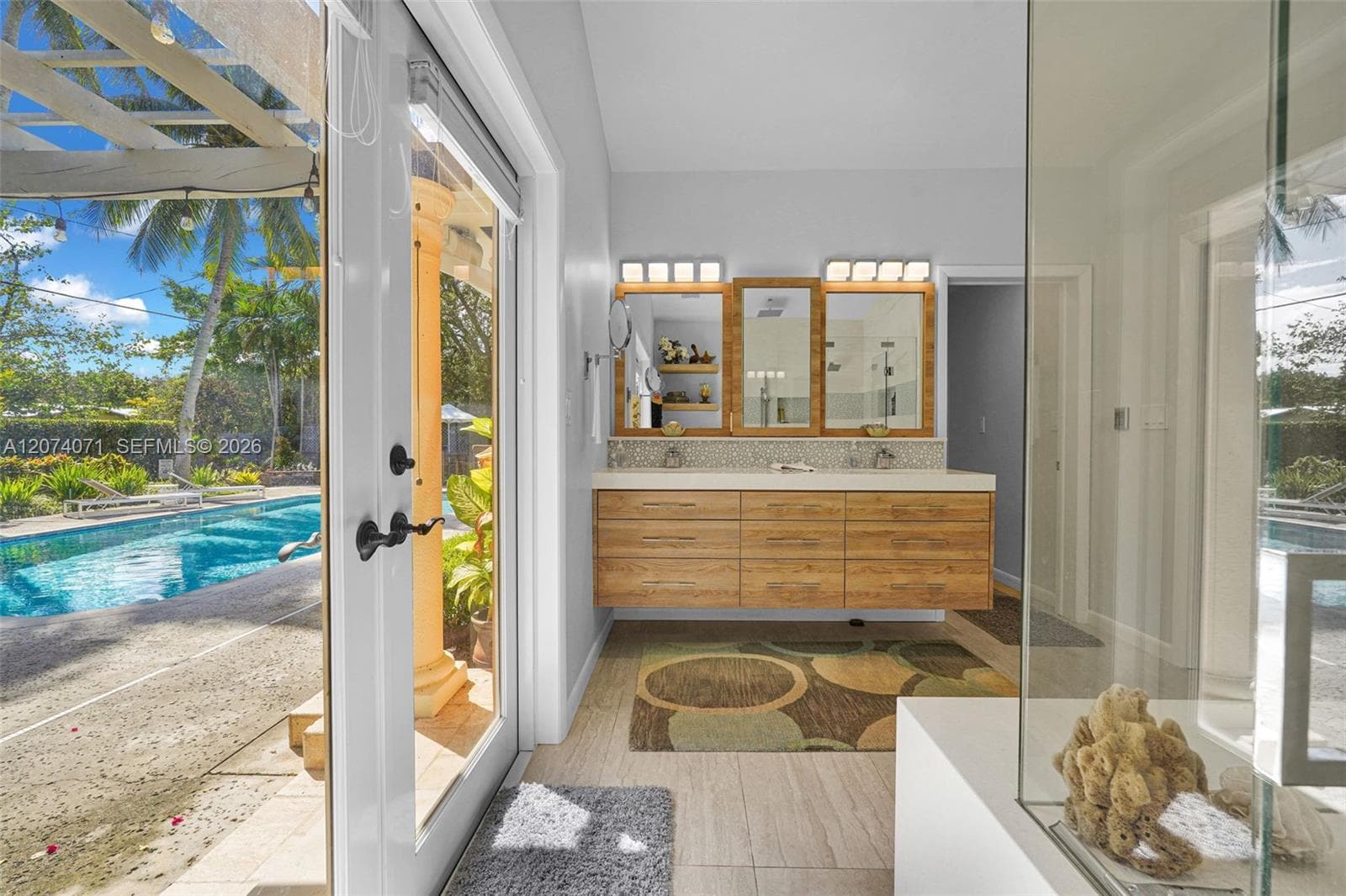 Renovated bathroom with modern vanity and natural light.